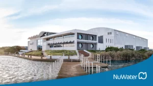 Exterior View Of The Nuwater Head Office Building In Capricorn Park, Featuring Modern Architecture And A Waterfront Setting.