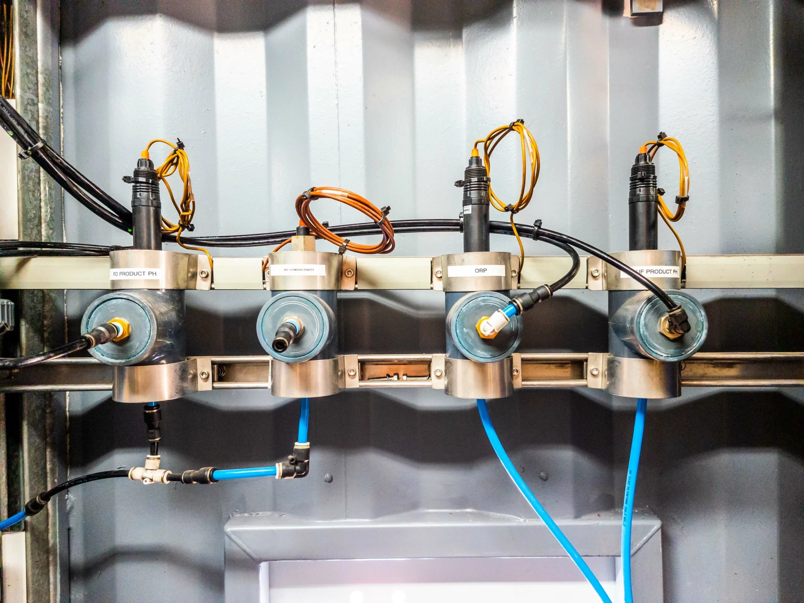 Close-Up Of Four Inline Sensors With Wires And Blue Tubing, Monitoring Water Parameters In The Treatment System.