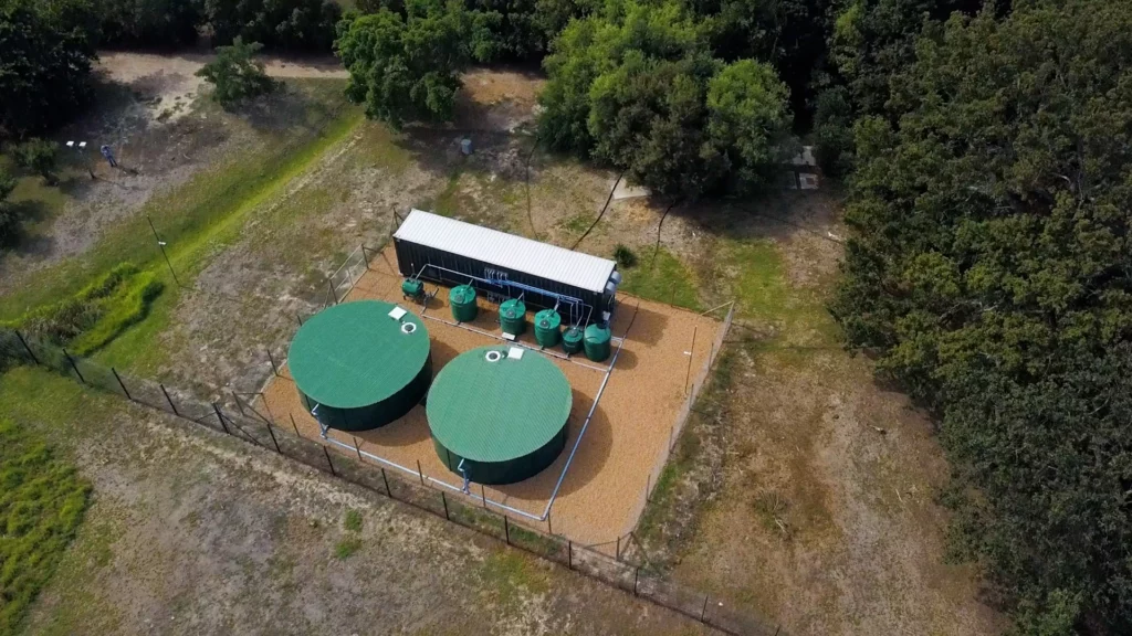 Aerial View Of The Nuwater Containerized Water Purification Plant And Storage Tanks On A Wine Estate In The Cape Winelands, With Mountains In The Background.
