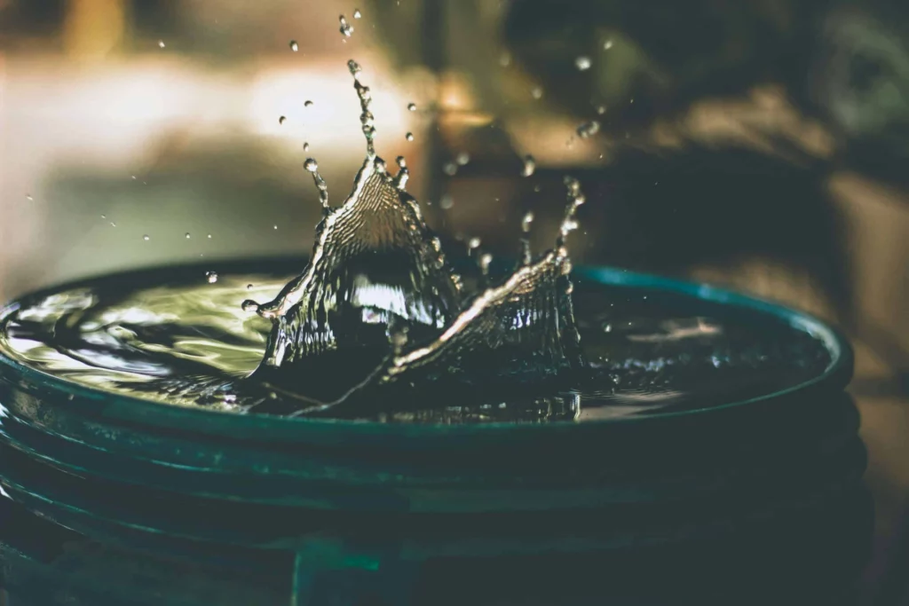 A Drop Of Water Splashing Into A Large Bucket Of Fresh Water From A Mobile Water Treatment Plant