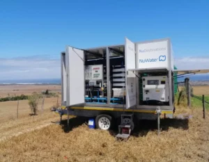 Nuwater Mobile Water Treatment Plant Trailer Deployed In A Field, Offering Portable And Flexible Water Purification Solutions.