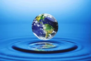Planet Earth Hovering Over Pure Water, Highlighting Sustainability Practices Like Water Recycling